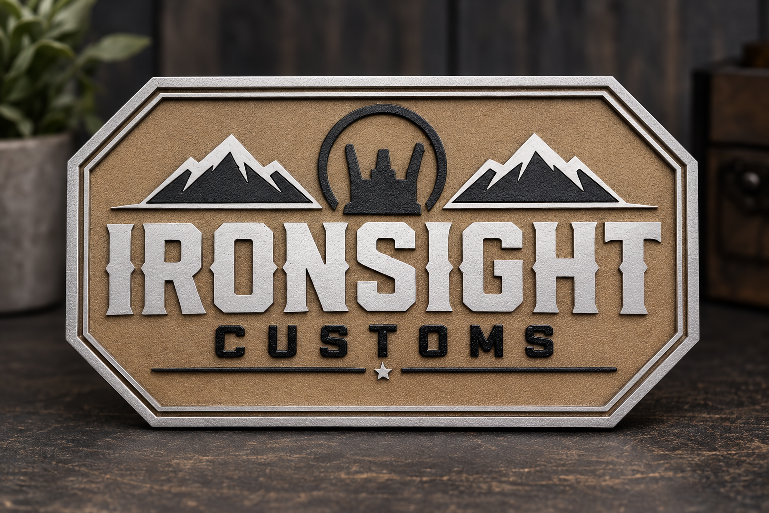 Laser-cut wooden Ironsight Customs logo display sign with metal frame on a workbench